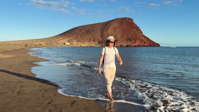 man walking near Atlantic ocean at el Medano Tenerife, Spain