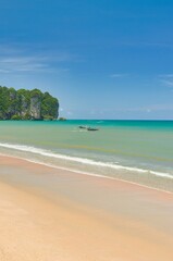 Fototapeta premium Thailand - Krabi - Ao Nang Beach July 27th 2025. This was on a beautiful morning during the wet season. The Andaman sea during the low season surrounded by beautiful mountains. 