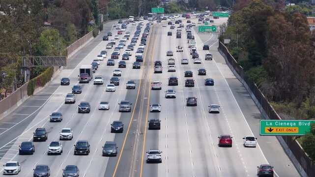 Heavy car traffic moving on interstate freeway in Los Angeles, California showing urban commuting, transportation, and infrastructure in major American city