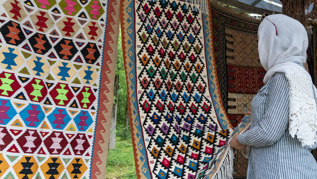 A woman buying a iranian handmade rug carpet