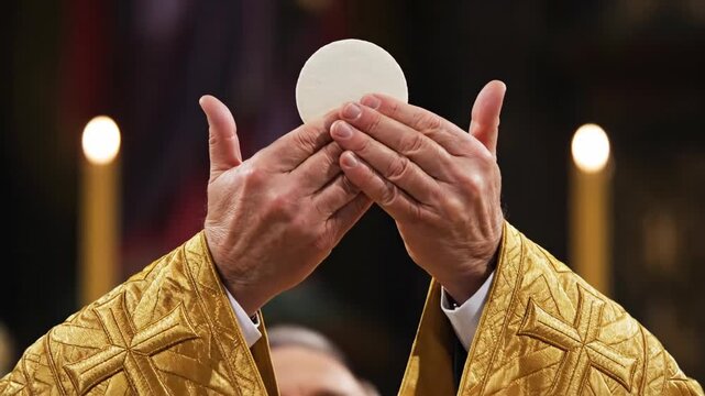 A Catholic priest elevates the host during Holy Communion. Close-up of the Eucharist consecration at a church mass. Sacred Christian religious service and faith concept