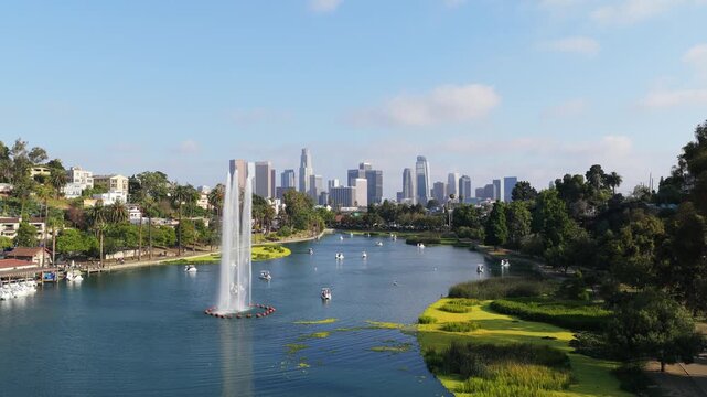 Scenic Echo Park Lake showcasing downtown Los Angeles skyline with iconic water fountain and pedal boats enjoying southern California sun