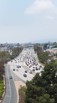 Los Angeles highway showing intense traffic with cars, trucks and other vehicles moving slowly along interstate 405, one of most congested freeways in America
