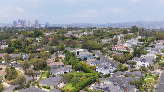 Los Angeles neighborhood with lush green trees, houses, streets, urban sprawl, southern California real estate concept