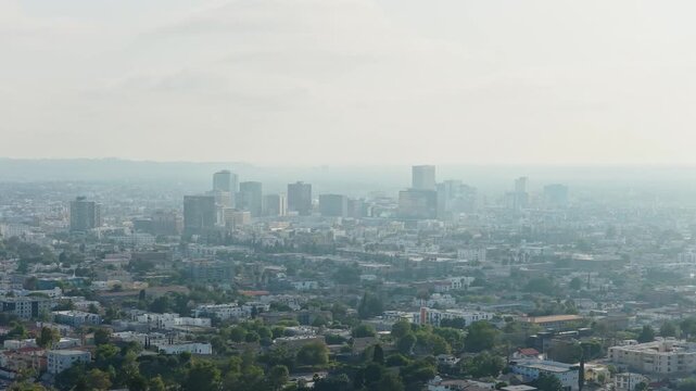 Hazy morning revealing Westwood skyscrapers and surrounding residential neighborhoods, major commercial and residential area in Los Angeles, California