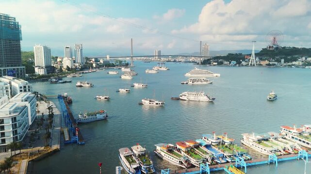 Halong bay cityscape featuring bai chay bridge, cruise ships, boats, and marina, highlighting tourism, travel, and economic development in quang ninh province, vietnam