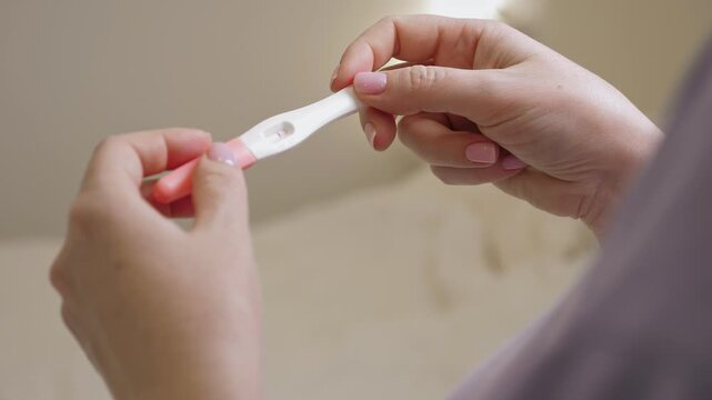 Woman holding in hands pregnancy test. Check quick pregnancy test kit
