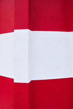 d&eacute;tail de la fa&ccedil;ade d'un phare en b&eacute;ton rouge et blanc