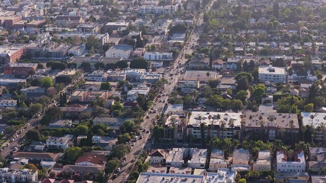 High angle of Los Angeles residential district showing urban sprawl, apartment building, family house, congested traffic on street