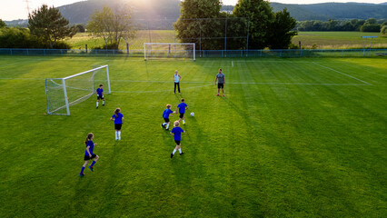 Children playing soccer game during youth football practice. © Halfpoint