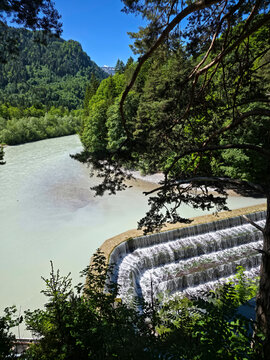 germany, spectacular lechfall waterfall viewed through forest branches with rushing water and enchanting natural scenery