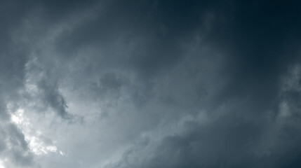 Fototapeta premium Panorama of the sky filled with light blue gray storm clouds 