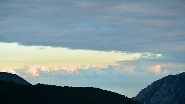 Stunning panoramic timelapse of rolling white clouds flowing over a majestic valley.