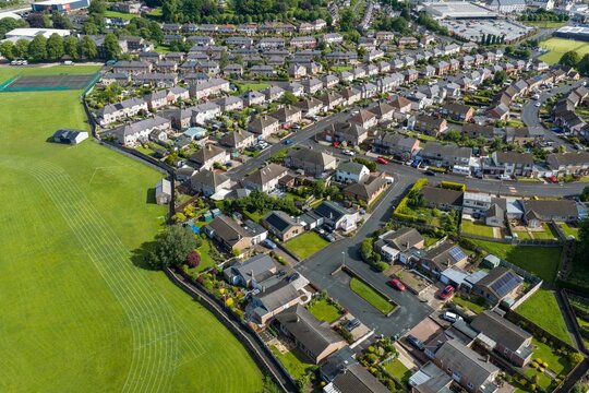 Aerial view of a residential neighbourhood in Penrith Cumbria England UK showing modern housing estates gardens local streets and community facilities on a bright summer afternoon