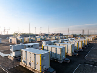 rows of energy storage battery containers at outdoor power station under blue sky © zhu difeng