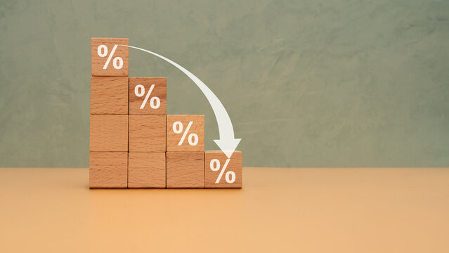 Interest Rates Decline Concept With Wooden Blocks Percentage Graph And Downward Arrow For Finance
