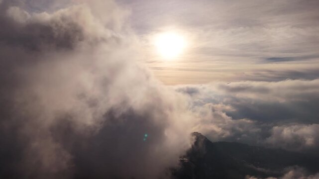 Epic aerial drone footage flying smoothly above a vast sea of white clouds under a clear blue sky.