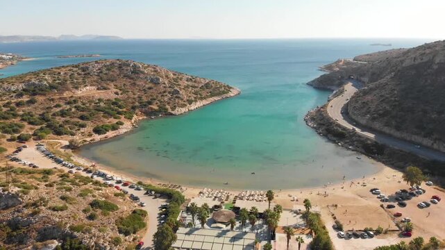 Aerial view of beach Paralia Lomvarda beach near Athens, Greece and seaside. Drone view from above. Sea and coast with sandy beach. Summer destination on the Mediterranean Sea, Europe
