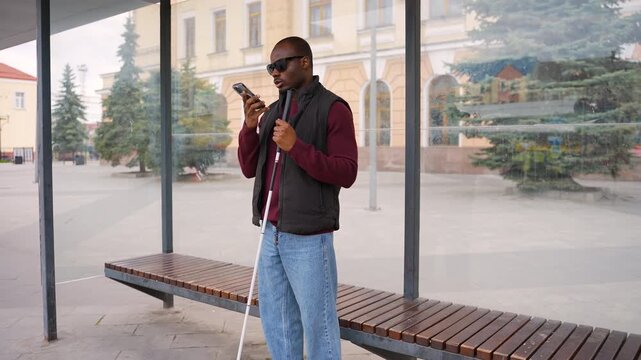 Blind African American man using smartphone voice assistant