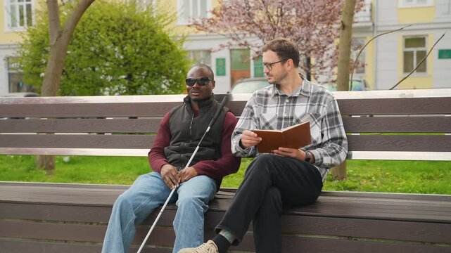Visually impaired man socializing with friend in park