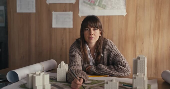 Woman designing an architectural project at a desk