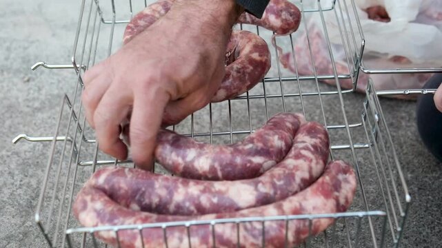 Close up of uncooked raw sausage showcasing its juicy texture, ideal for flavorful dishes and culinary creativity. black background. top view. High quality 4k footage