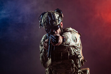 Obraz premium Soldier equipped with rifle and night vision goggles posing in tactical gear. Concept security, military service and combat readiness. 