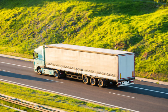 Cargo Semi Truck Driving on Highway Through Green Countryside