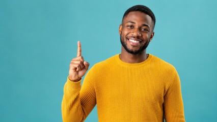 Fototapeta premium Smiling Man Pointing Up with Finger Isolated on Blue Background Presenting Copy Space for Advertisement