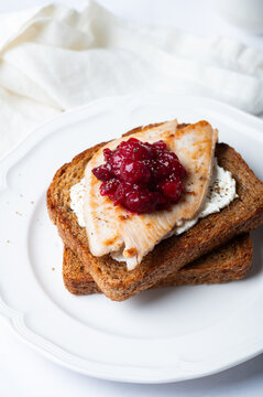 Open Sandwich with leftover turkey slices with cranberry sauce on top. Perfect holiday breakfast or lunch
