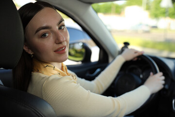 Naklejka premium Woman behind steering wheel of modern car