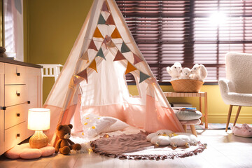 Beautiful wigwam, cushions and toys in child's room © New Africa
