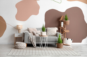 Interior of living room with sofa, bookshelf and Cypress trees © Pixel-Shot