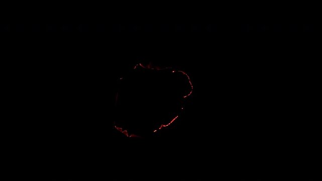 Irregular circular fire hole with two large upper flames and a fragmented glowing burn edge, isolated on black for dramatic reveals and VFX compositing.