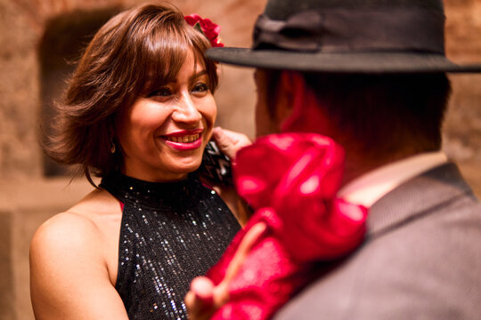 A couple of adults, elegantly dressed, dancing the cueca brava, she staring intently. National holidays. Traditional Chilean dance, national dance.