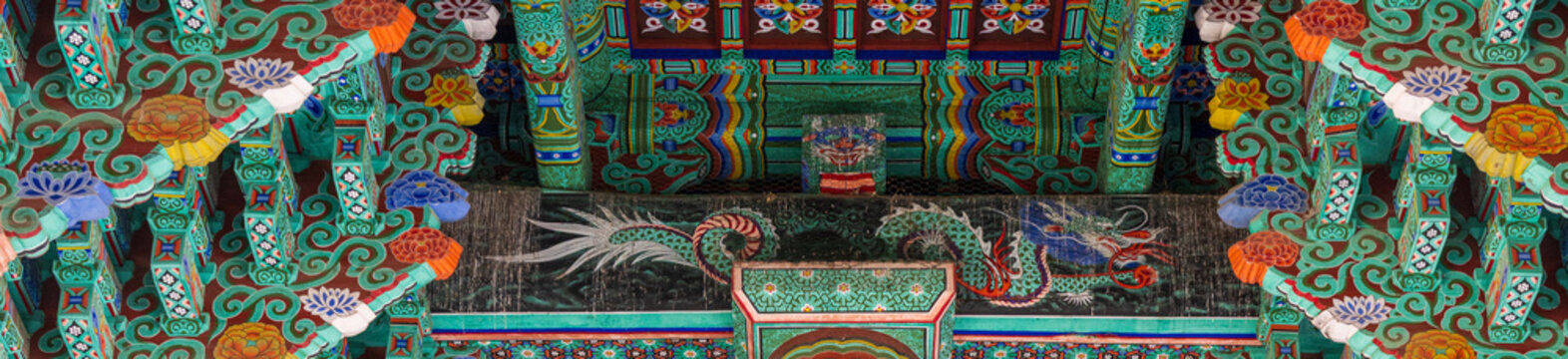Beautiful dancheong patterns and dragon painting on the ceiling of a traditional korean temple.