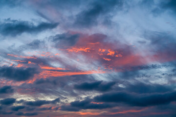 Fototapeta premium Colorful sunset clouds cover the wide evening sky over the dark Key West ocean horizon during the tropical summer season.