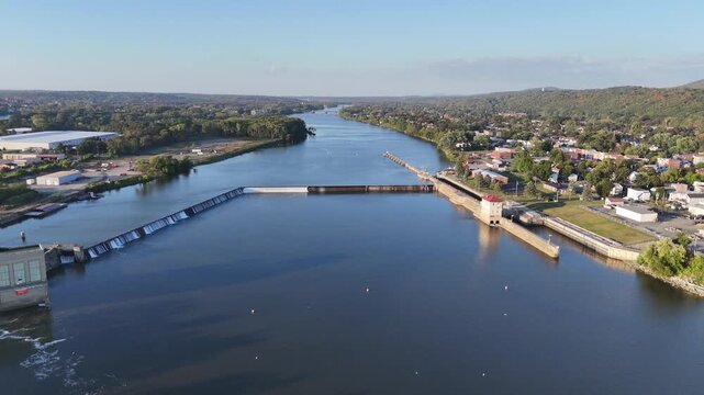 Aerial view at sunset of the dam on the Hudson River at Troy, New York, with river vanishing into the horizon 
