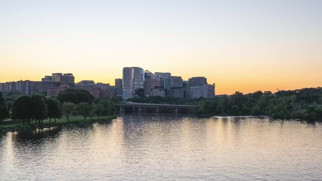 Arlington, Virginia, scenic static 4K timelapse video capturing the transitioning gradient sky over the illuminated Rosslyn skyline as office lights flicker and ripples move across the Potomac River a