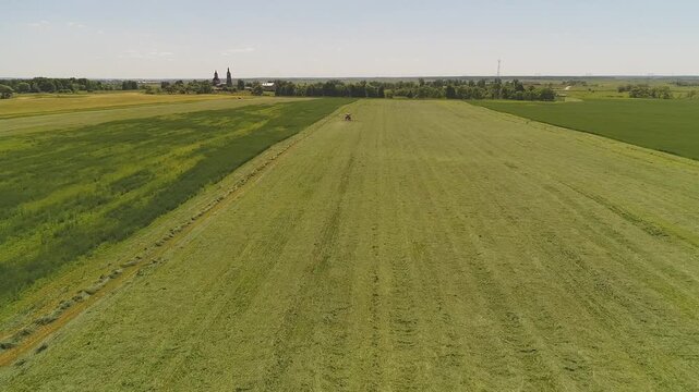 Drone advancing forward above working tractor