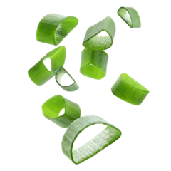 Cut green onion falling on transparent background © New Africa