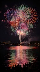Fototapeta premium Vibrant Fireworks Display Over Water at Night