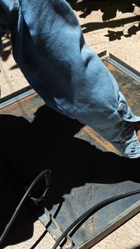 Heavy Scrubbing of Metal Cover with Steel Wire Brush