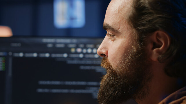 Happy software engineer feeling satisfied after removing all bugs while coding on computer, close up. Joyous IT admin looking at PC screen, pleased after solving script errors. close up.