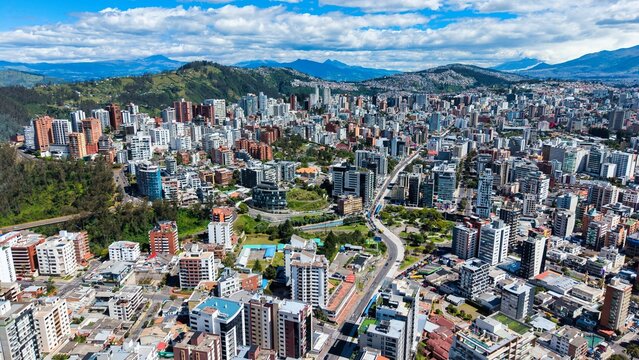 View of Quito City With Buildings and Green Spaces Under a Cloudy Sky in Daytime
