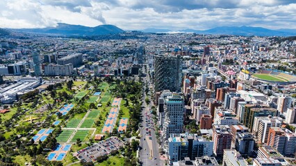 Naklejka premium View of Quito City With Green Parks and Modern Buildings Under a Cloudy Sky in the Middle of the Day
