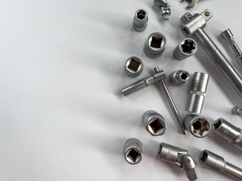 Top view of various sizes of silver chrome socket heads and tools.