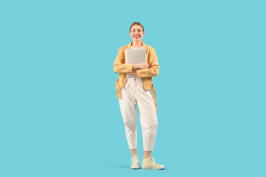 Female programmer with laptop on blue background