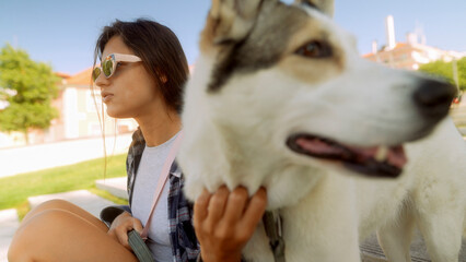 Woman with husky outdoors on a sunny day © teksomolika