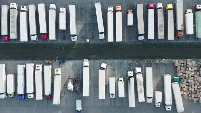 Logistics Park Truck Parking Lot Aerial Top Down View | Semi Trailers Waiting for Loading and Unloading | Supply Chain and Freight Transport